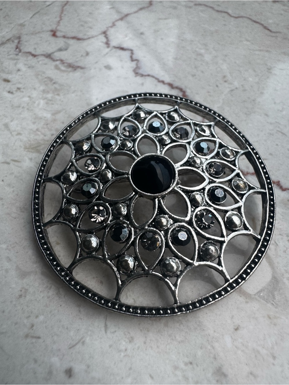 Silver-Tone Floral Filigree Brooch with Black Stones